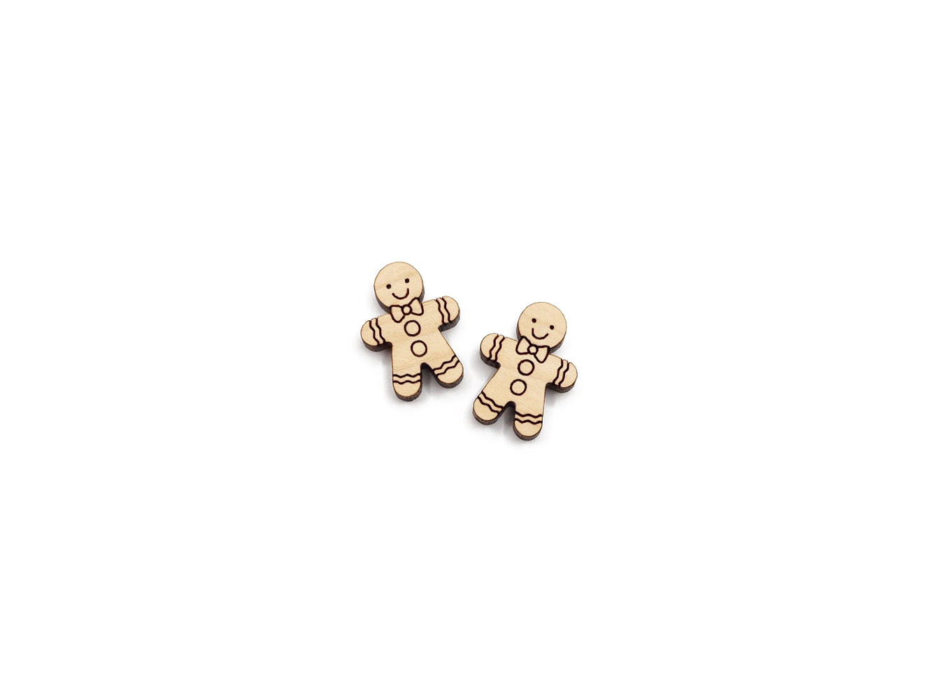 a pair of wooden cabochon stud earring blanks cut and engraved to look like a gingerbread man