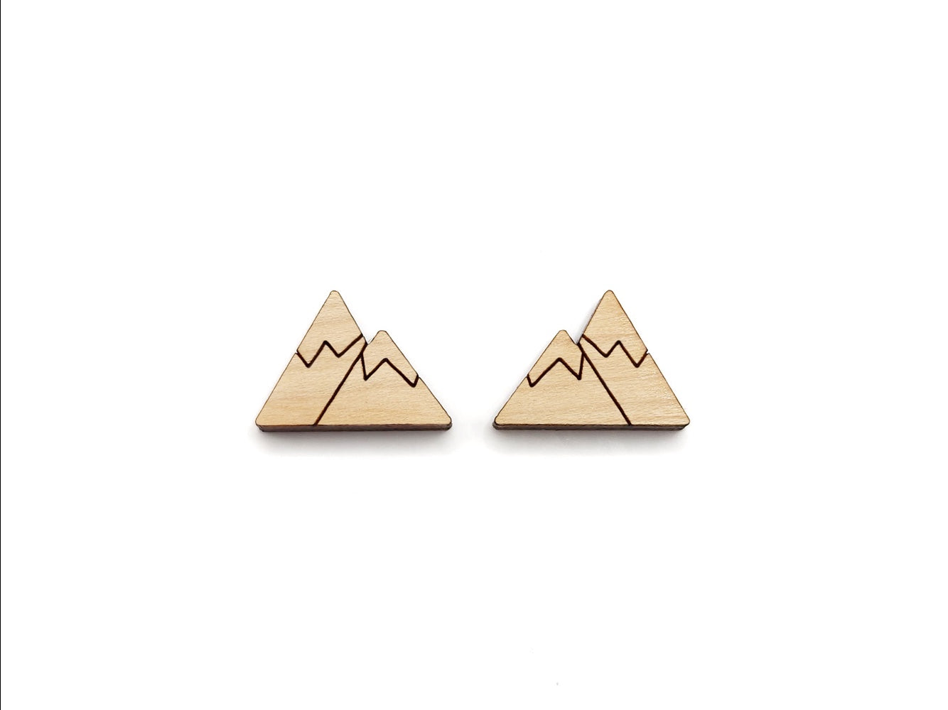 a pair of wooden cabochon stud earring blanks cut and engraved to look like snow-capped mountains