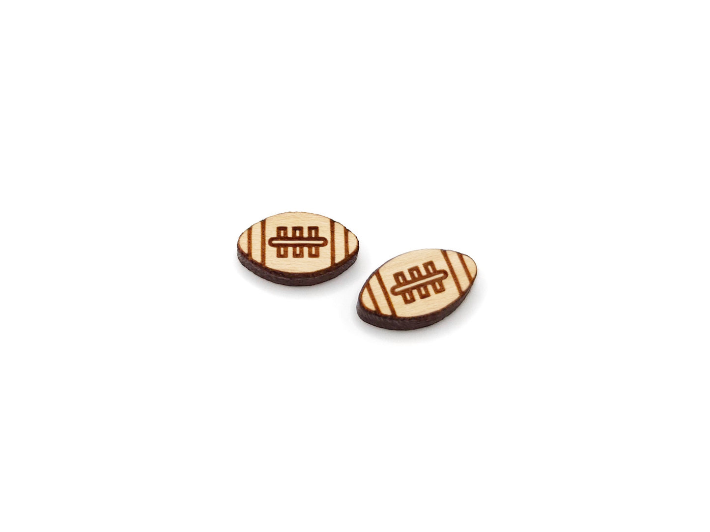 a pair of wooden cabochon stud earring blanks cut and engraved to look like a football