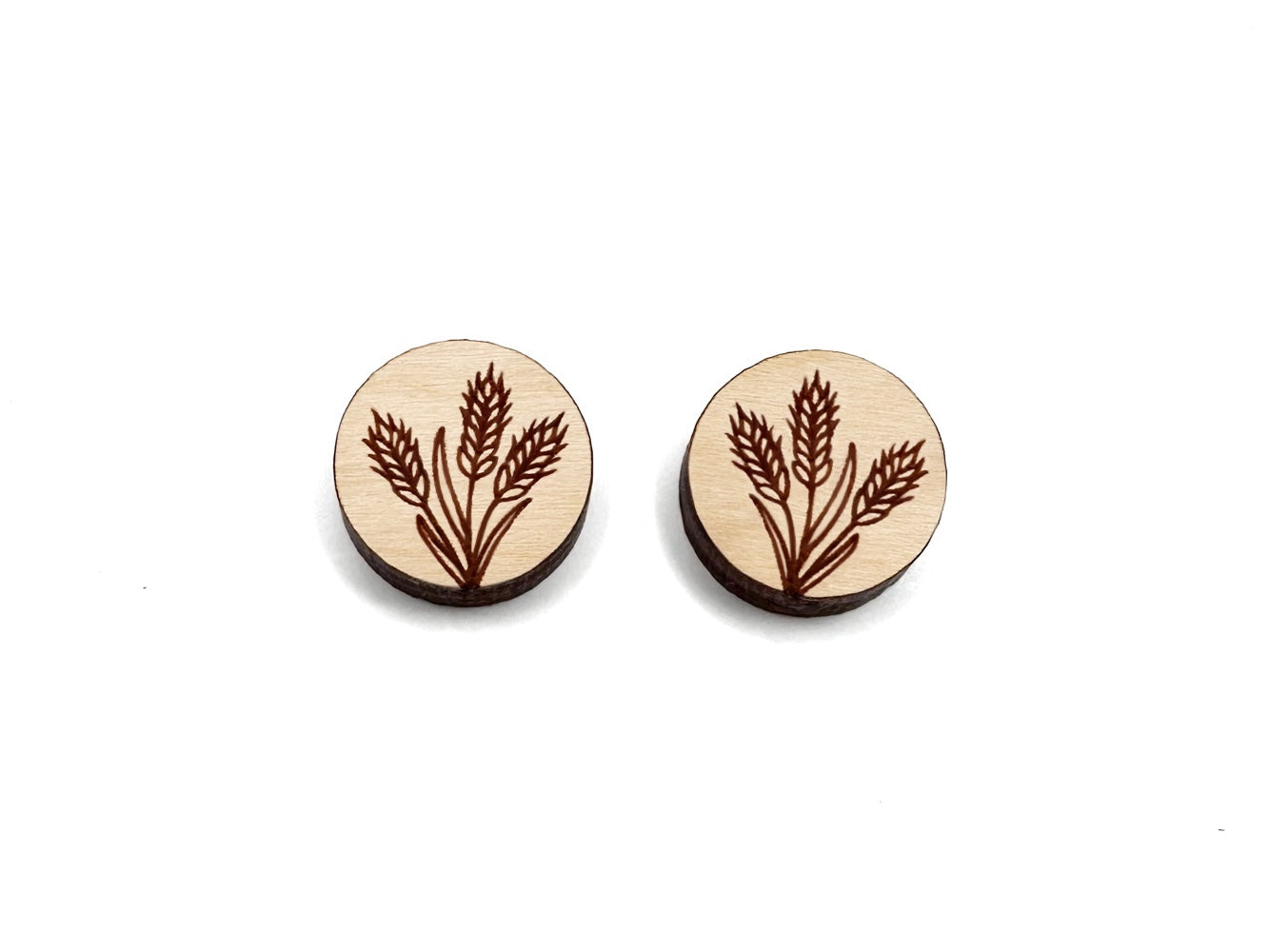 a pair of round wooden cabochon earring blanks engraved with a wheat design