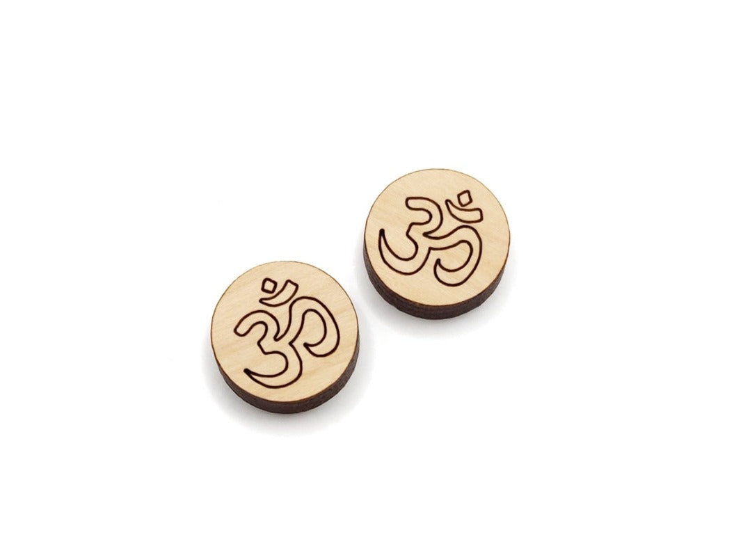 A pair of round wood cabochon earring blanks, engraved with an om yoga design.