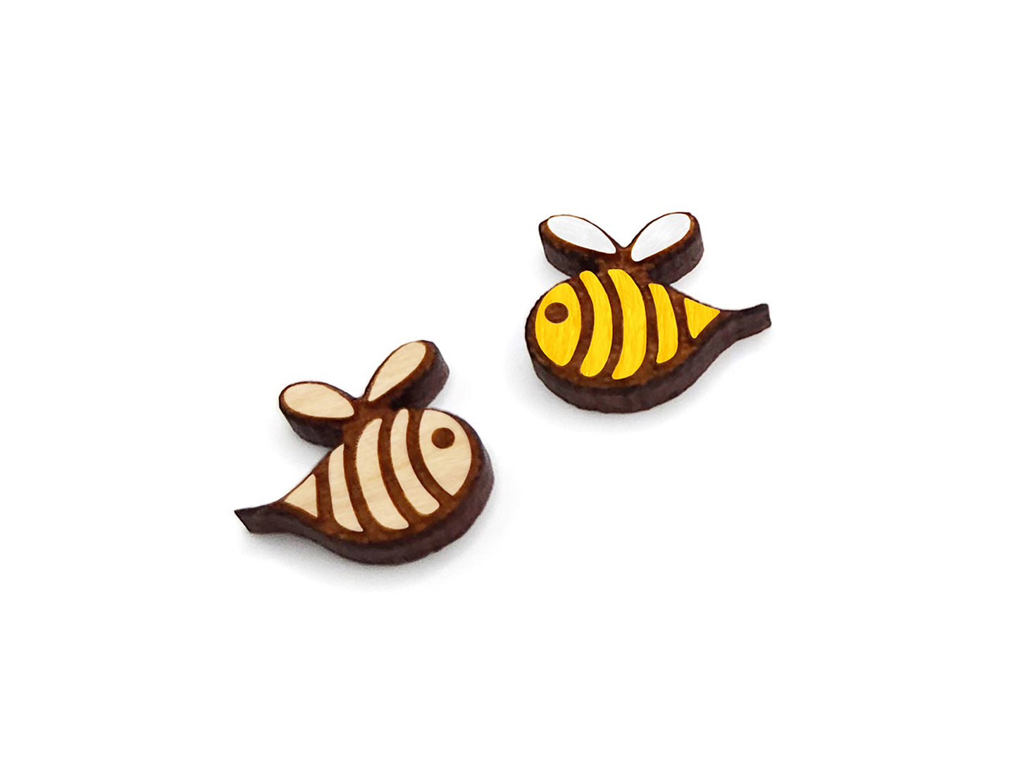 a pair of small wooden cabochon blanks for stud earrings, cut and engraved to look like bees