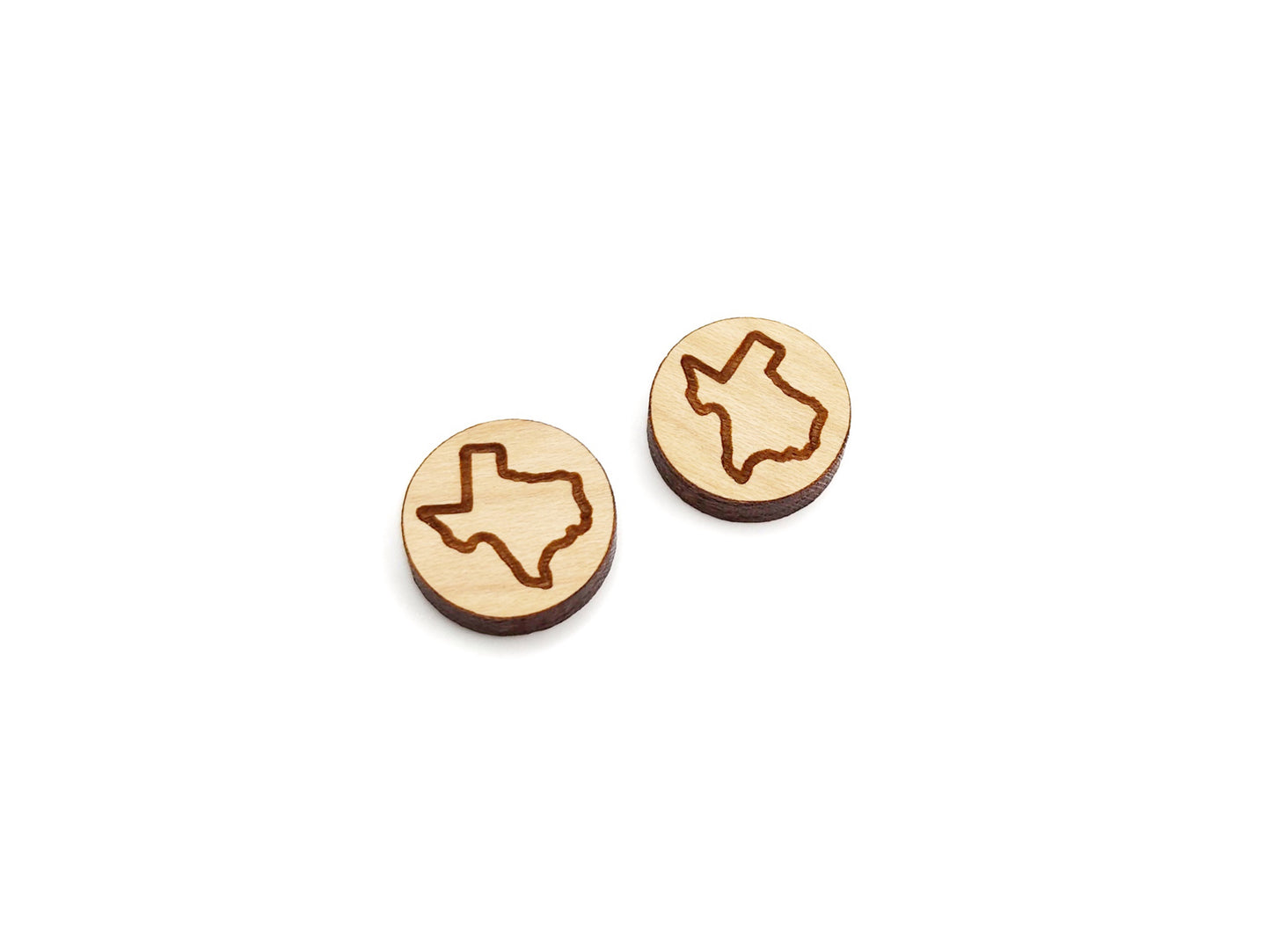 a pair of round wooden cabochon earring blanks engraved with the outline of Texas
