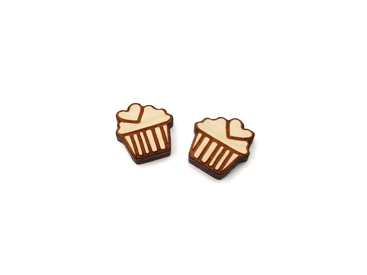 a pair of wooden cabochon stud earring blanks cut and engraved to look like a cupcake