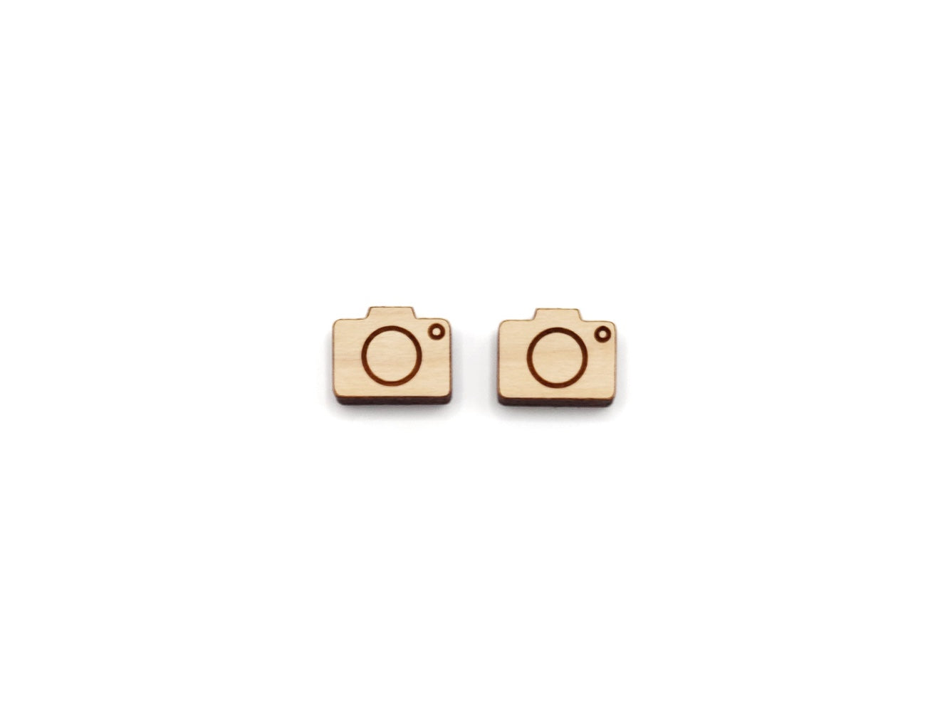 a pair of wooden cabochon stud earring blanks cut and engraved to look like a camera