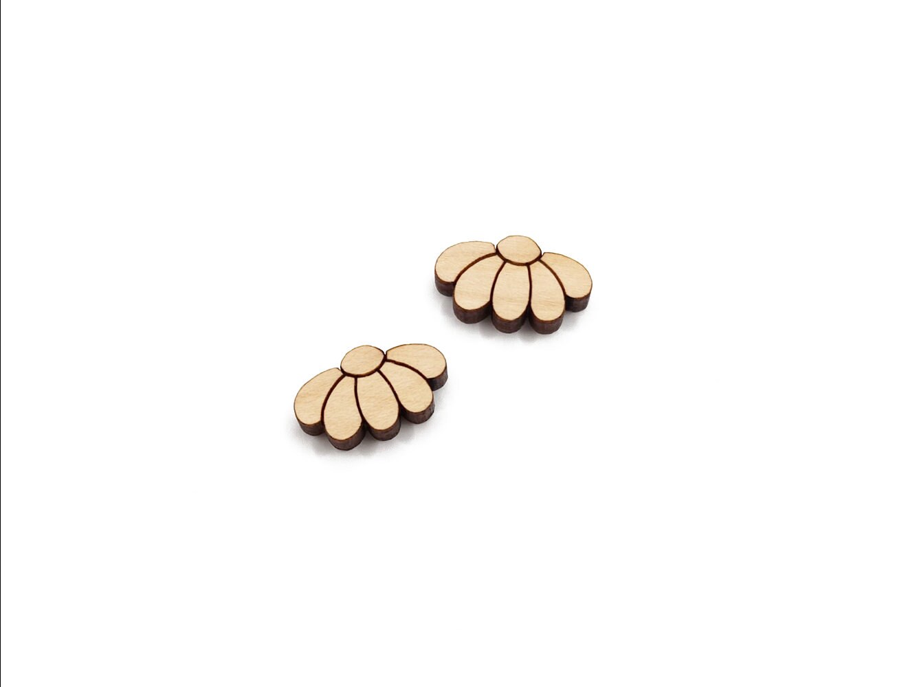 a pair of wooden cabochon stud earring blanks cut and engraved to look like daisy flowers