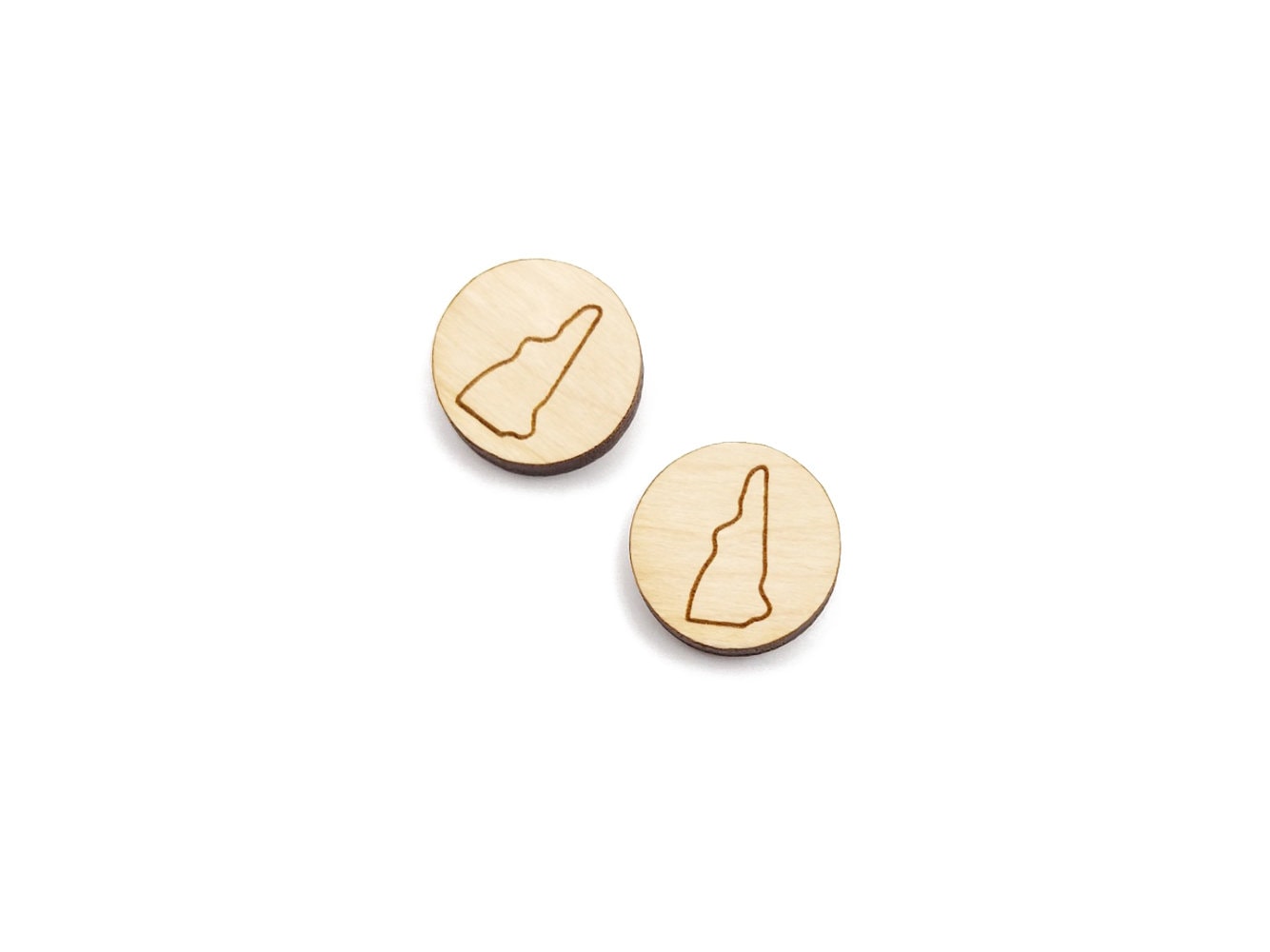 a pair of round wooden cabochon earring blanks engraved with an outline of New Hampshire