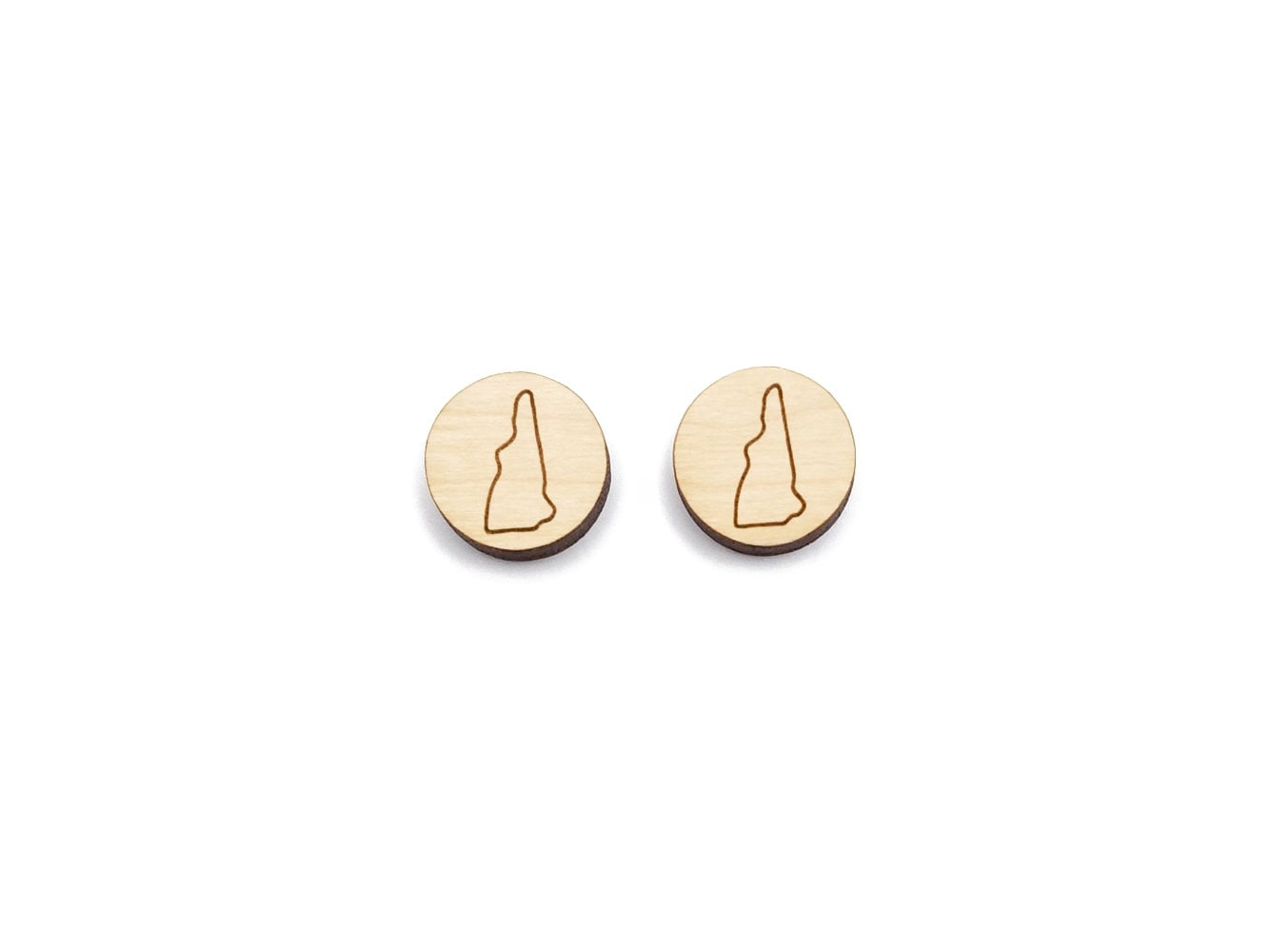 a pair of round wooden cabochon earring blanks engraved with an outline of New Hampshire