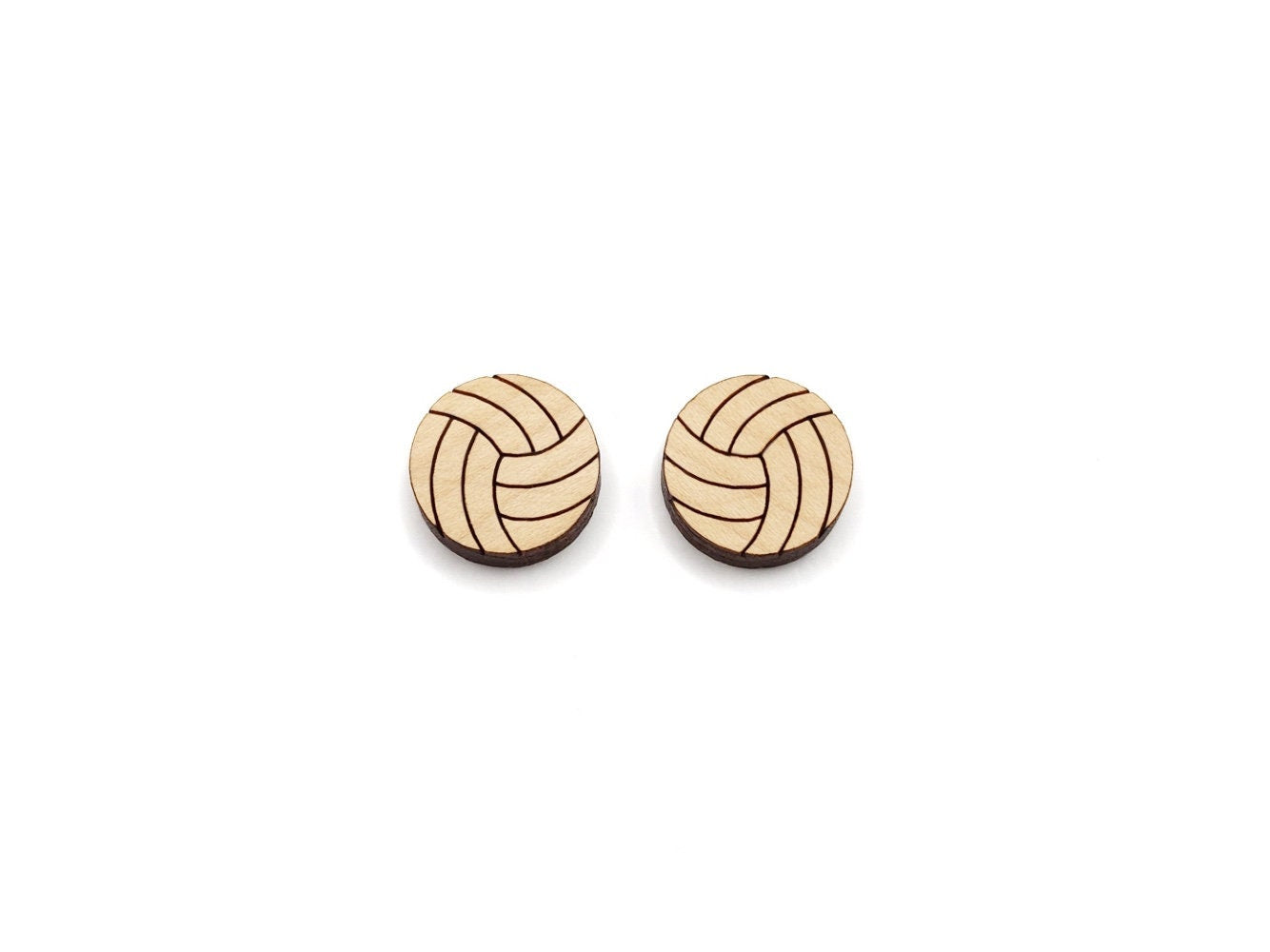 a pair of wooden cabochon stud earring blanks cut and engraved to look like volleyballs