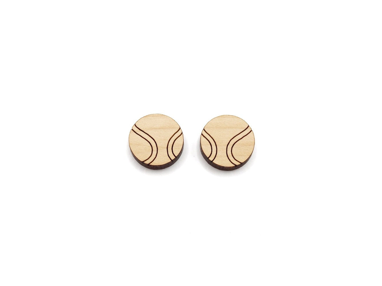 a pair of wooden cabochon stud earring blanks cut and engraved to look like tennis balls