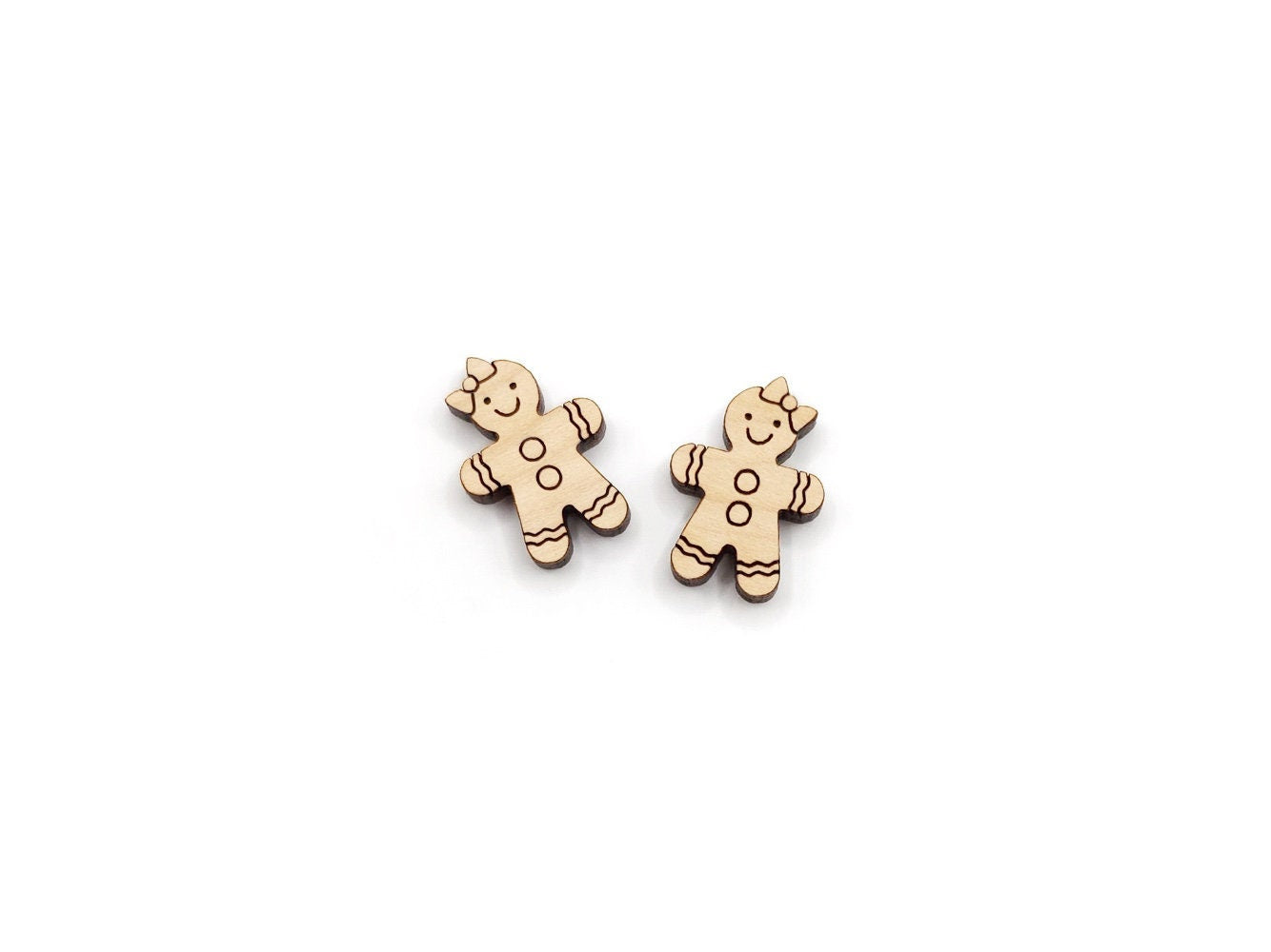 a pair of wooden cabochon stud earring blanks cut and engraved to look like a gingerbread girl