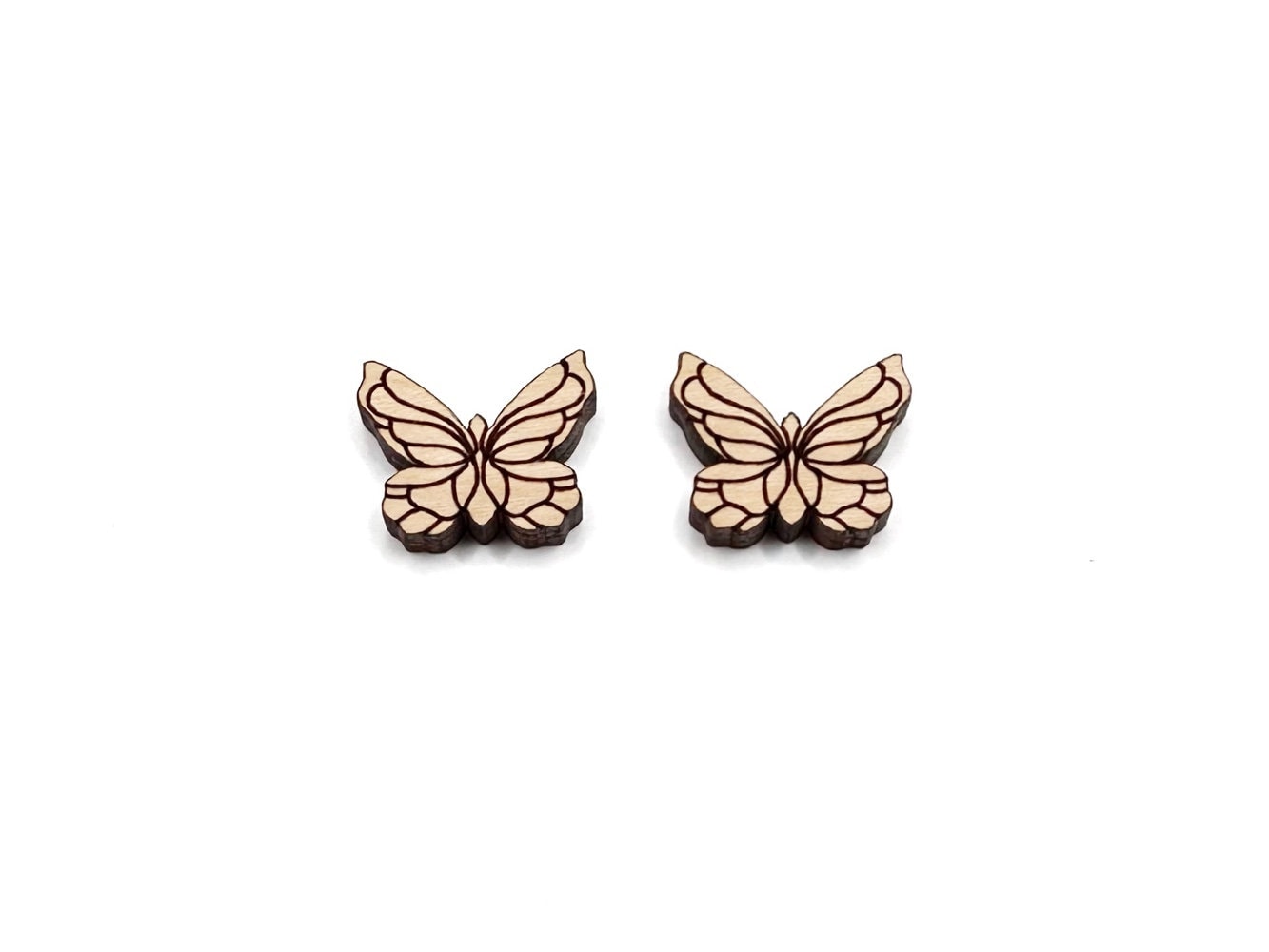 a pair of wooden cabochon stud earring blanks cut and engraved to look like butterflies