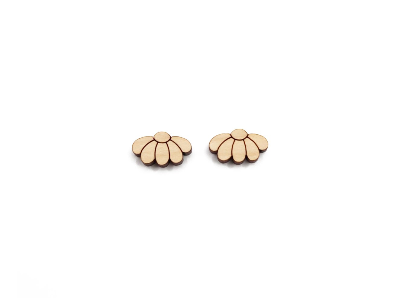 a pair of wooden cabochon stud earring blanks cut and engraved to look like daisy flowers