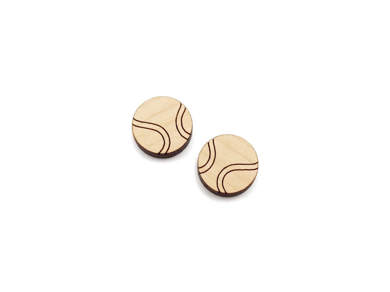 a pair of wooden cabochon stud earring blanks cut and engraved to look like tennis balls