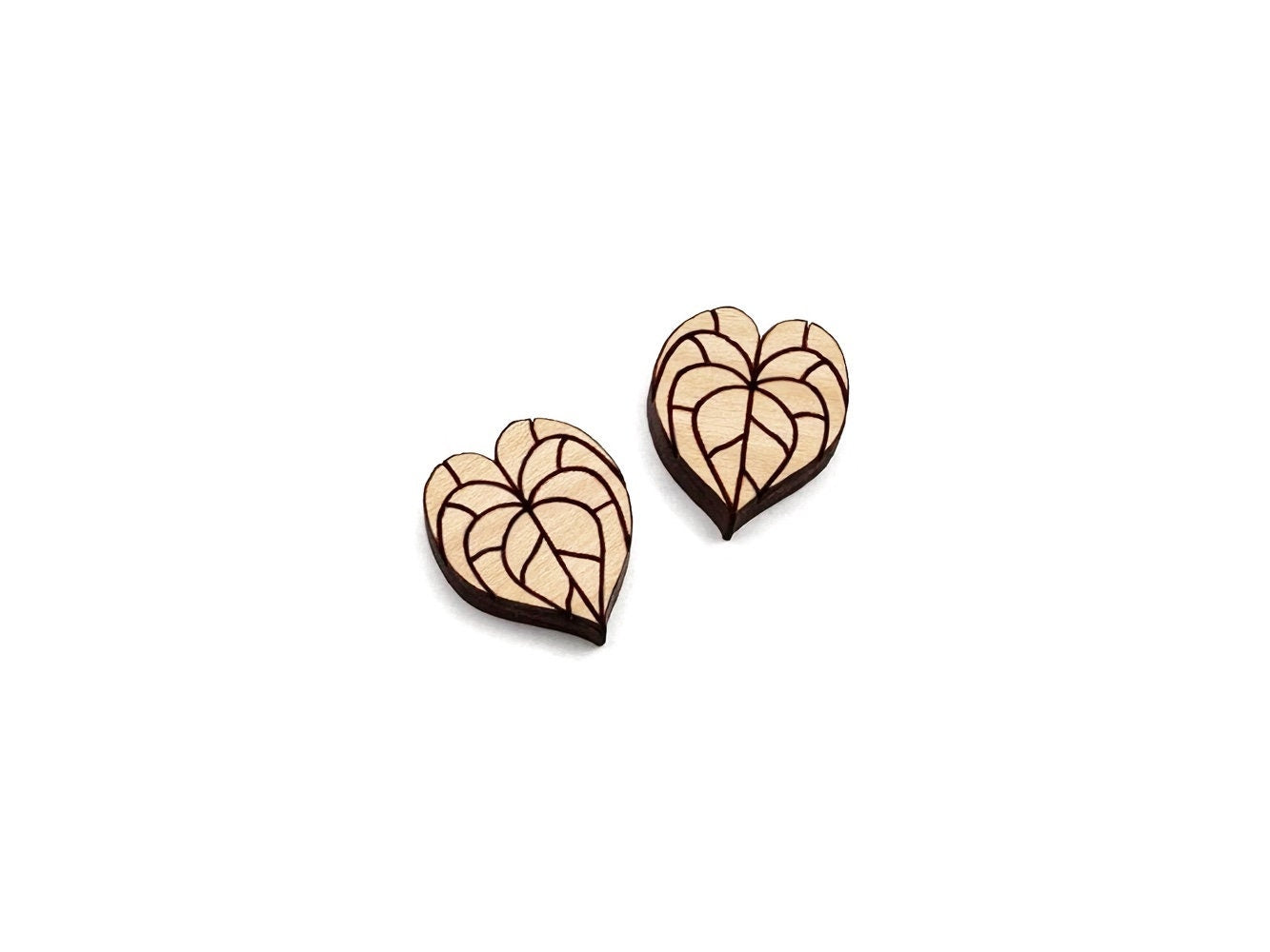 a pair of wooden cabochon stud earring blanks cut and engraved to look like anthurium leaves