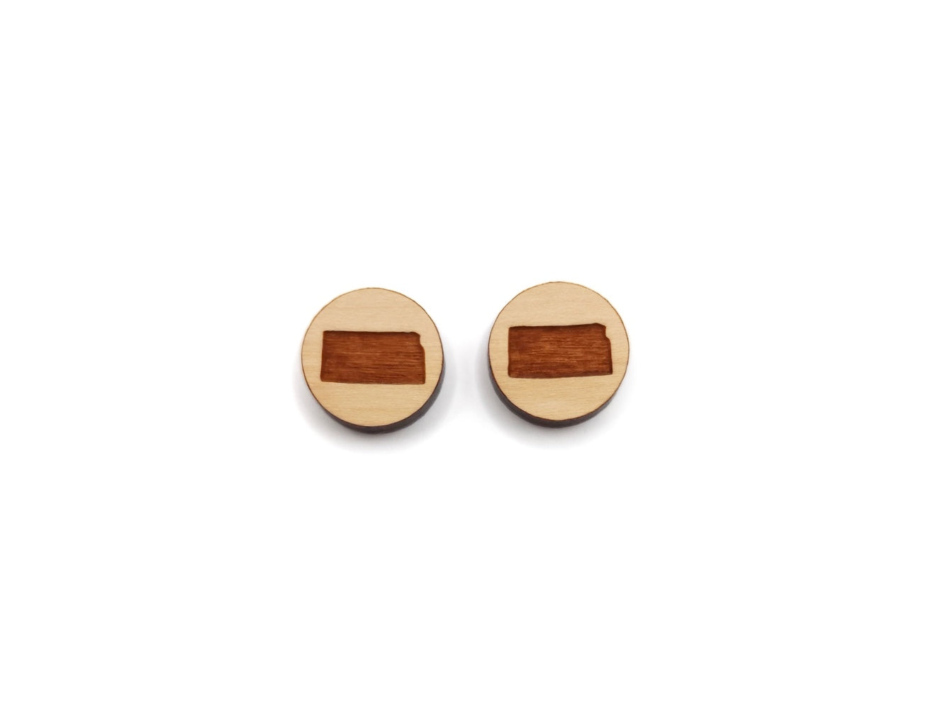 a pair of round wooden cabochon earring blanks engraved with the state of Kansas