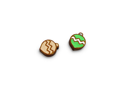 a pair of wooden cabochon stud earring blanks cut and engraved to look like a Christmas ornament