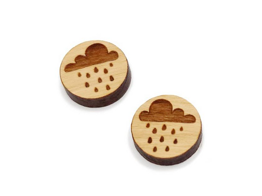 a pair of round wooden cabochon earring blanks engraved with a rain cloud design