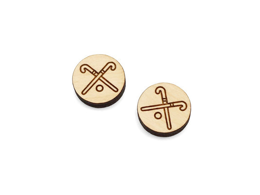 a pair of small round wooden cabochon blanks for stud earrings engraved with a field hockey stick design