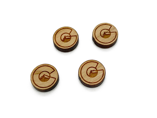 four wooden buttons with a letter g on them