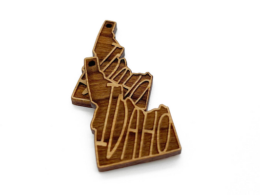 a wooden brooch with the shape of a map