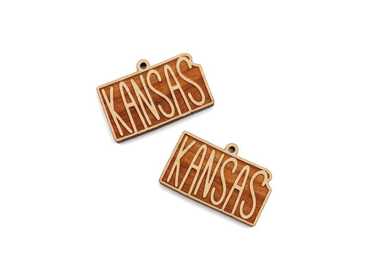 two wooden name tags with the word kansas on them